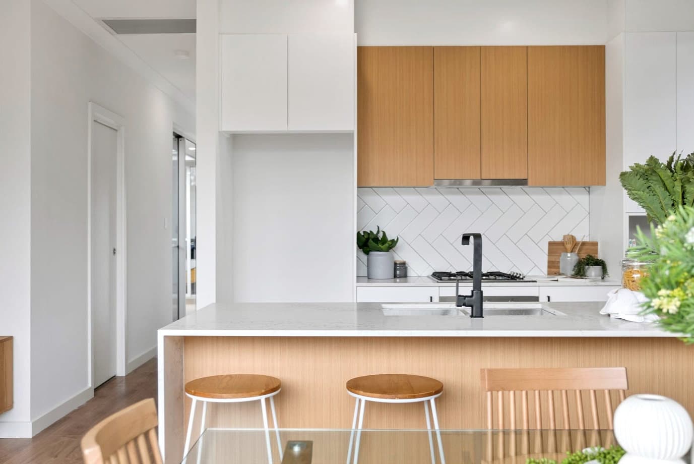 Kitchen with stone island bench and stools