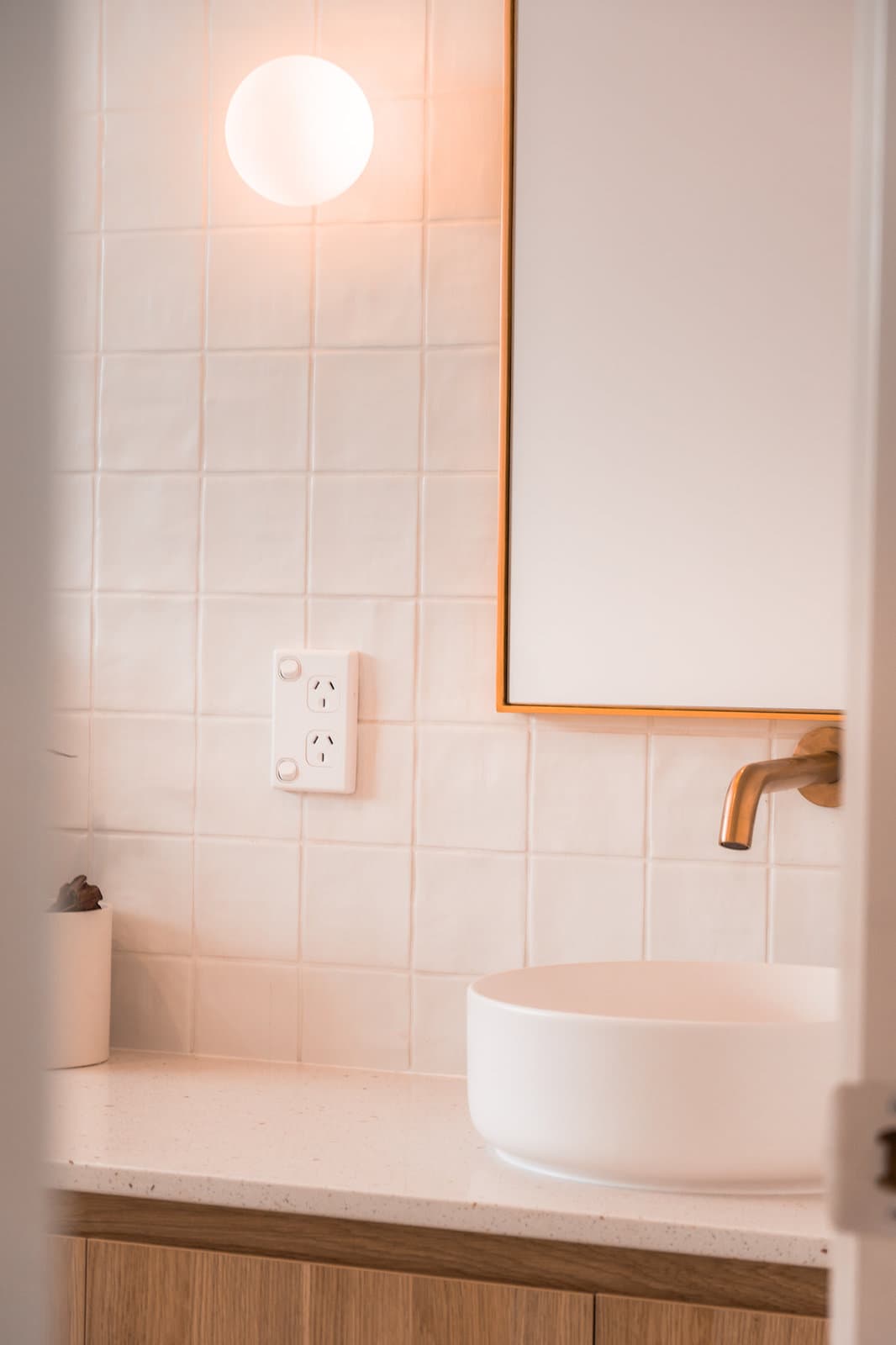 Floor to ceiling tiling with brass wall-mounted tapware
